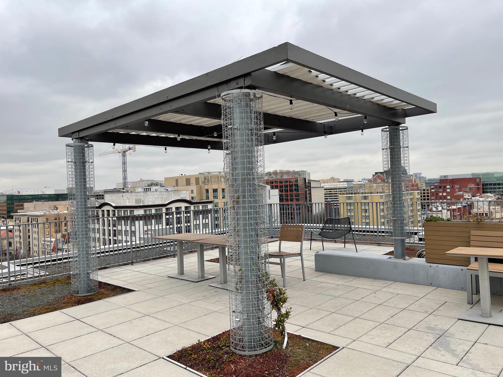 1 Scott Circle Northwest, Unit 118 Washington, DC 20005 - Photo 30 of 35 a roof deck view with a bench and potted plants