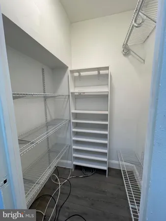 a view of walk in closet with empty racks
