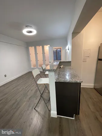 a view of kitchen island wooden floor and living room