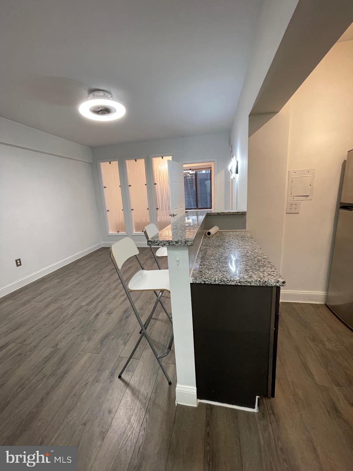 1 Scott Circle Northwest, Unit 118 Washington, DC 20005 - Photo 10 of 35 a view of kitchen island wooden floor and living room
