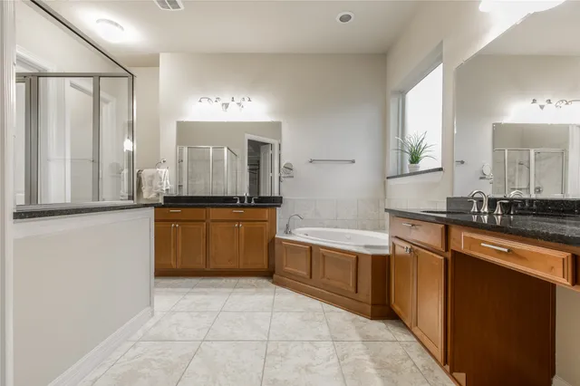 a large kitchen with granite countertop a sink and cabinets