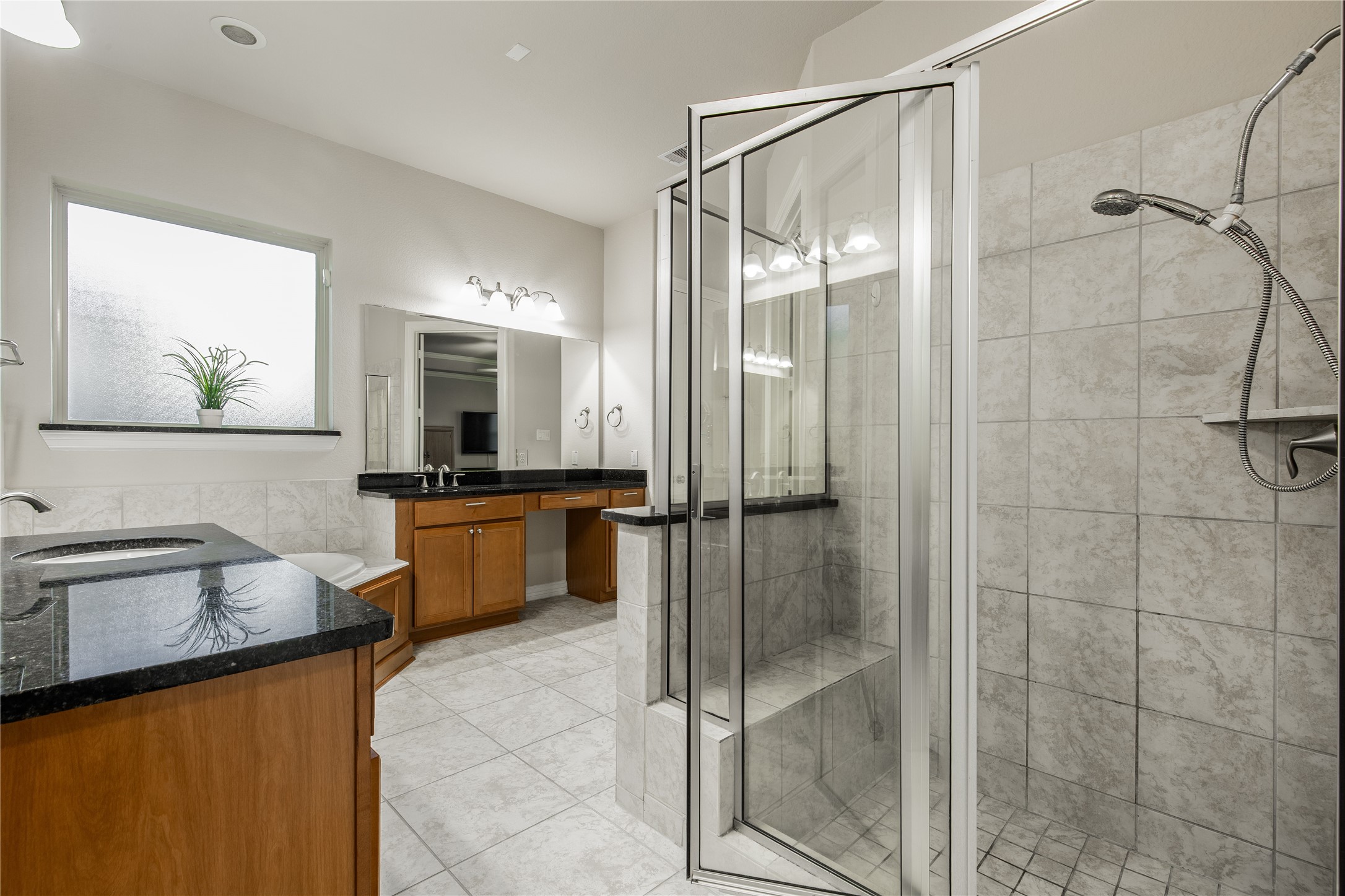 2607 Tree Swallow Bluff Path Spring, TX 77389 - Photo 21 of 50 a bathroom with a granite countertop sink mirror and shower