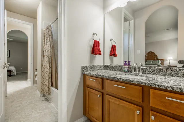 a bathroom with cabinets sink and mirror