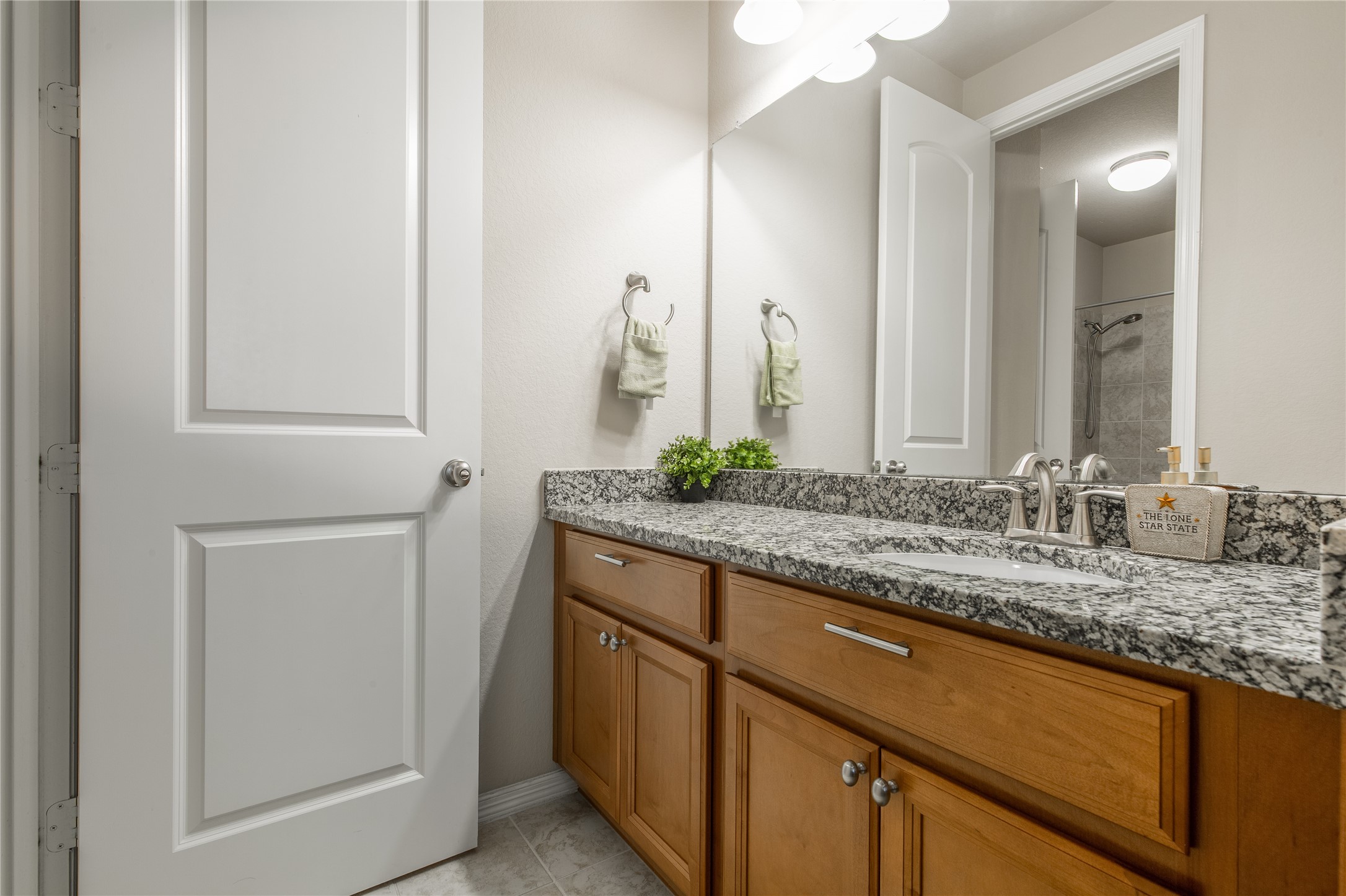 2607 Tree Swallow Bluff Path Spring, TX 77389 - Photo 33 of 50 a bathroom with a granite countertop sink and a mirror