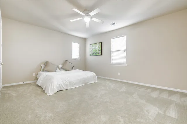 a living room with furniture a air conditioner and a table