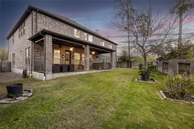 a swimming pool with outdoor seating and yard