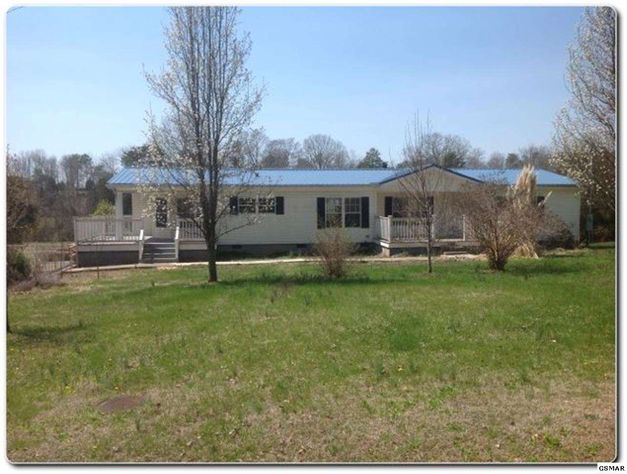 7651 Gibbs Road Corryton, TN 37721 - Photo 1 of 1 a front view of house with yard and green space