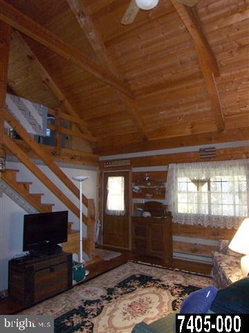 7728 Gnatstown Road Hanover, PA 17331 - Photo 15 of 25 a view of a hallway with wooden floor and a fireplace