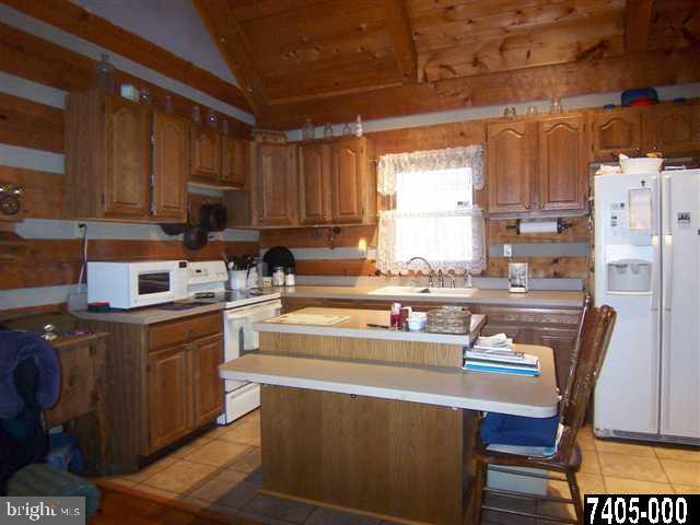 7728 Gnatstown Road Hanover, PA 17331 - Photo 18 of 25 a kitchen with stainless steel appliances a stove a sink cabinets and a dining table