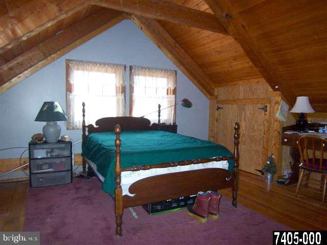 7728 Gnatstown Road Hanover, PA 17331 - Photo 23 of 25 a bedroom with a bed and a table in it