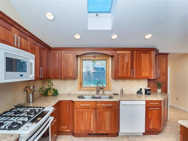 14 Colorado Street Springfield, MA 01118 - Photo 8 of 22 a kitchen with stainless steel appliances granite countertop a stove a sink and a microwave