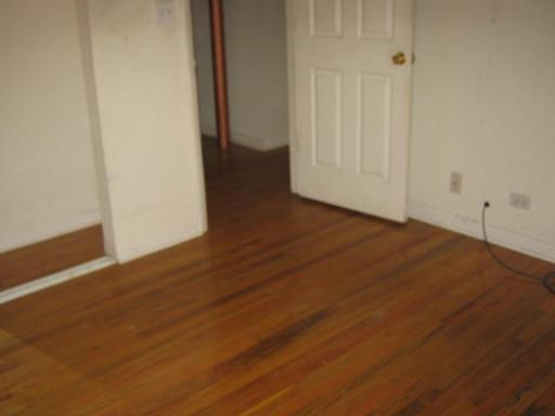8142 South Drexel Avenue, Unit G Chicago, IL 60619 - Photo 6 of 11 a view of an empty room with wooden floor