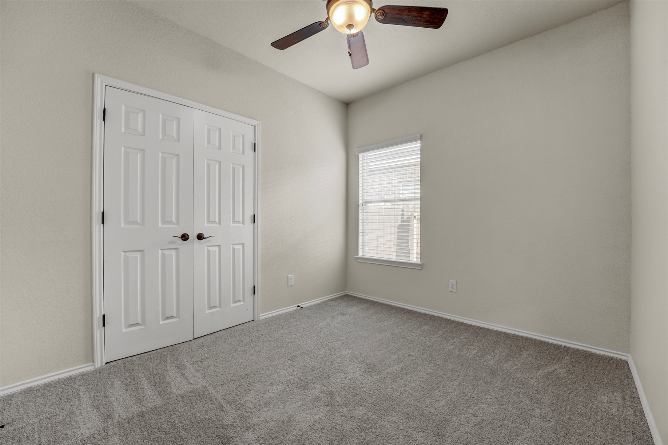 10506 Corvey Lane Helotes, TX 78023 - Photo 16 of 28 Unfurnished bedroom with a ceiling fan, carpet, and a closet