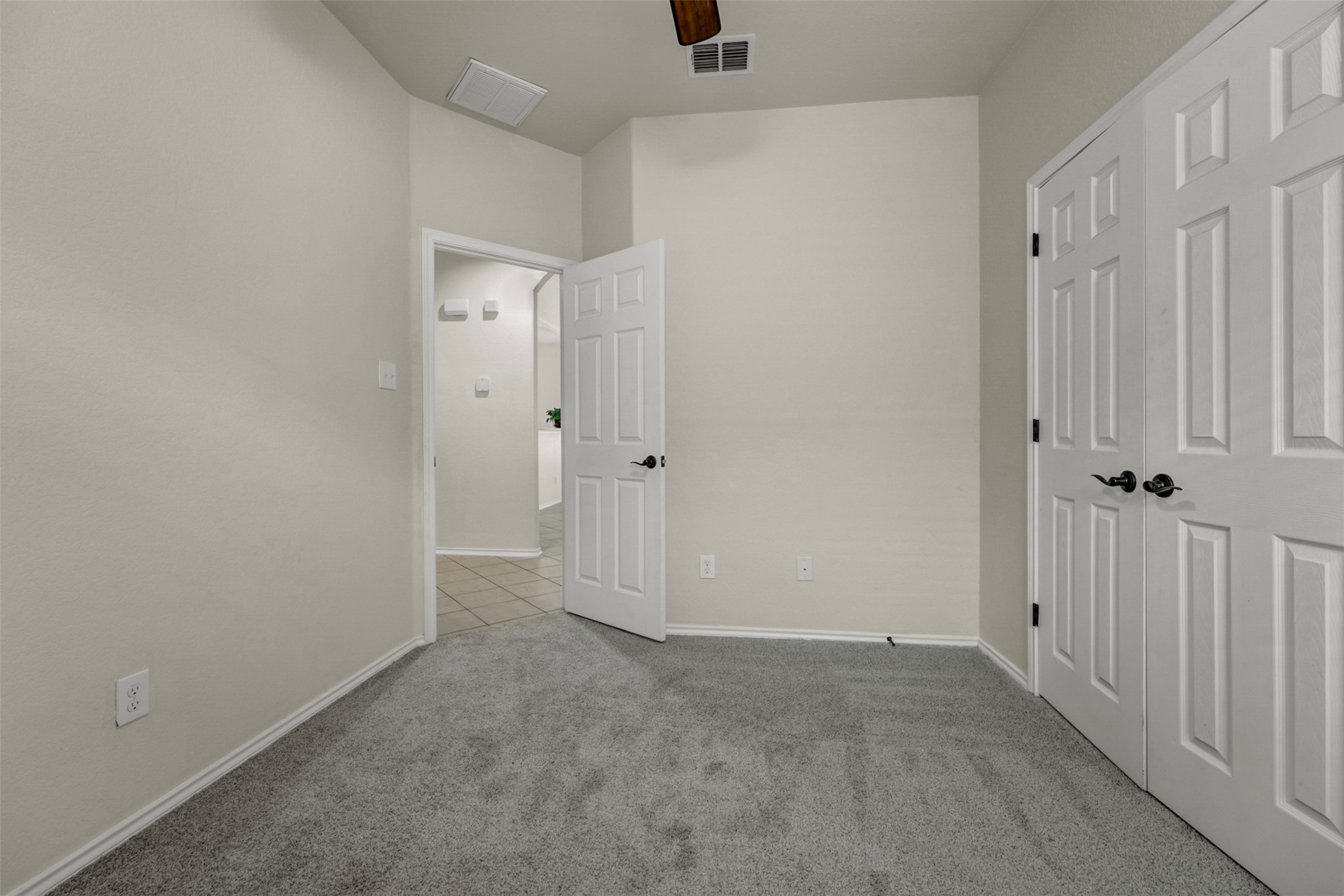 10506 Corvey Lane Helotes, TX 78023 - Photo 17 of 28 Unfurnished bedroom with light carpet and ceiling fan