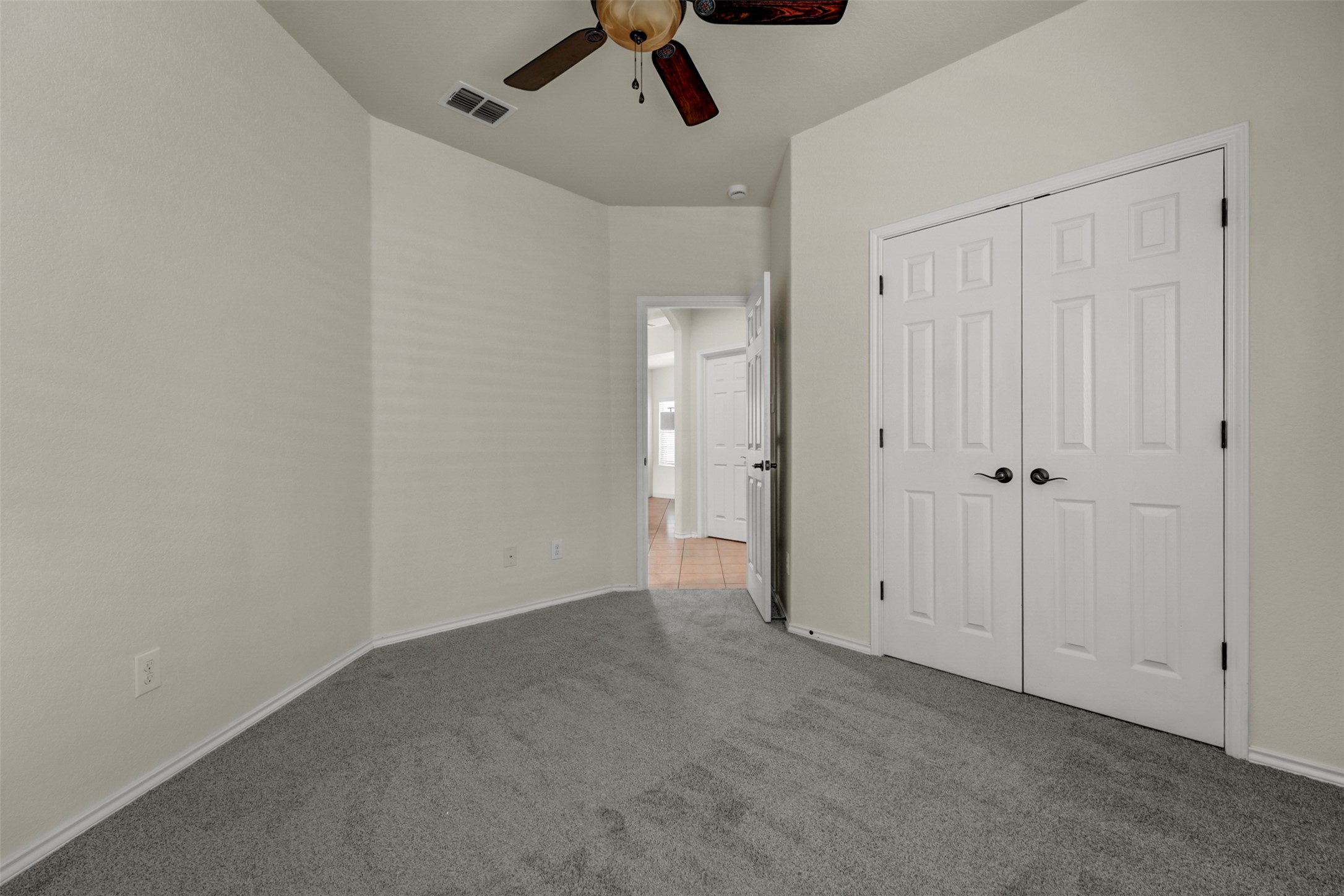 10506 Corvey Lane Helotes, TX 78023 - Photo 20 of 28 Unfurnished bedroom featuring carpet flooring, a ceiling fan, and a closet