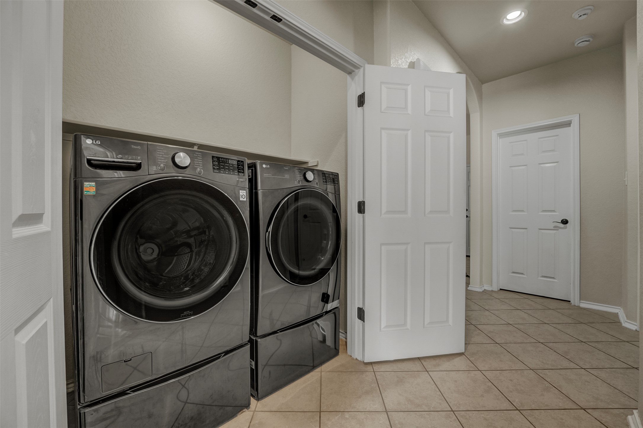 10506 Corvey Lane Helotes, TX 78023 - Photo 21 of 28 Laundry area with light tile patterned floors, recessed lighting, and separate washer and dryer