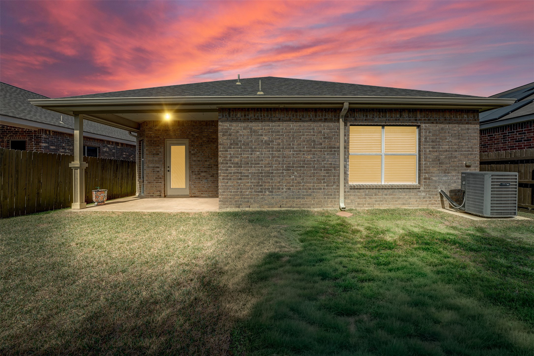 10506 Corvey Lane Helotes, TX 78023 - Photo 22 of 28 Back of property at dusk with a patio area, a fenced backyard, brick siding, and a shingled roof