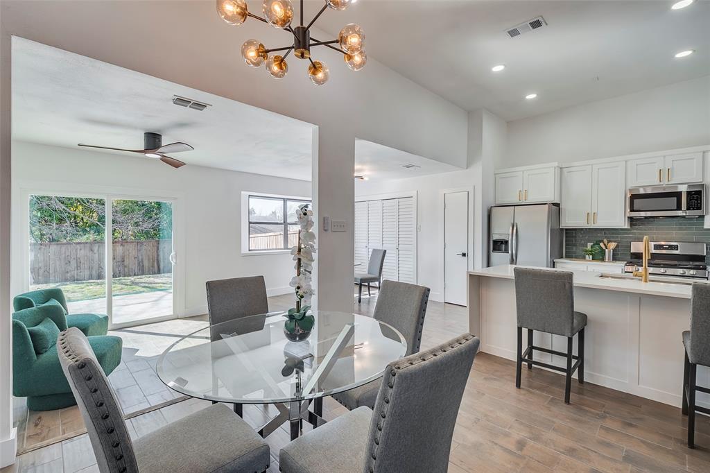 5607 Emrose Circle Dallas, TX 75227 - Photo 16 of 25 a view of a dining room with furniture window and wooden floor