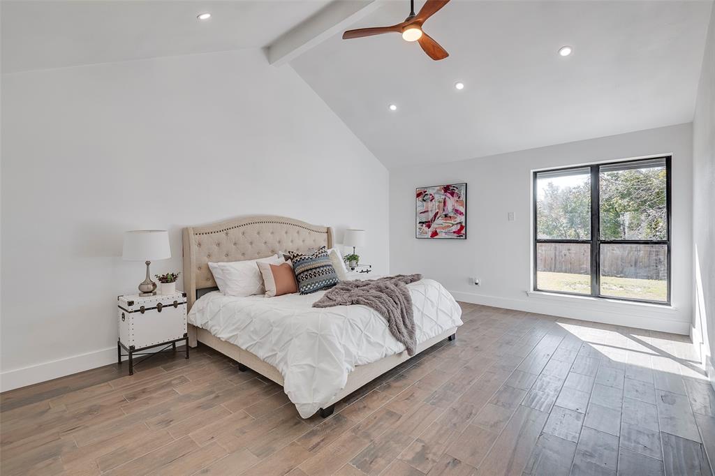 5607 Emrose Circle Dallas, TX 75227 - Photo 20 of 25 a spacious bedroom with a bed and a window