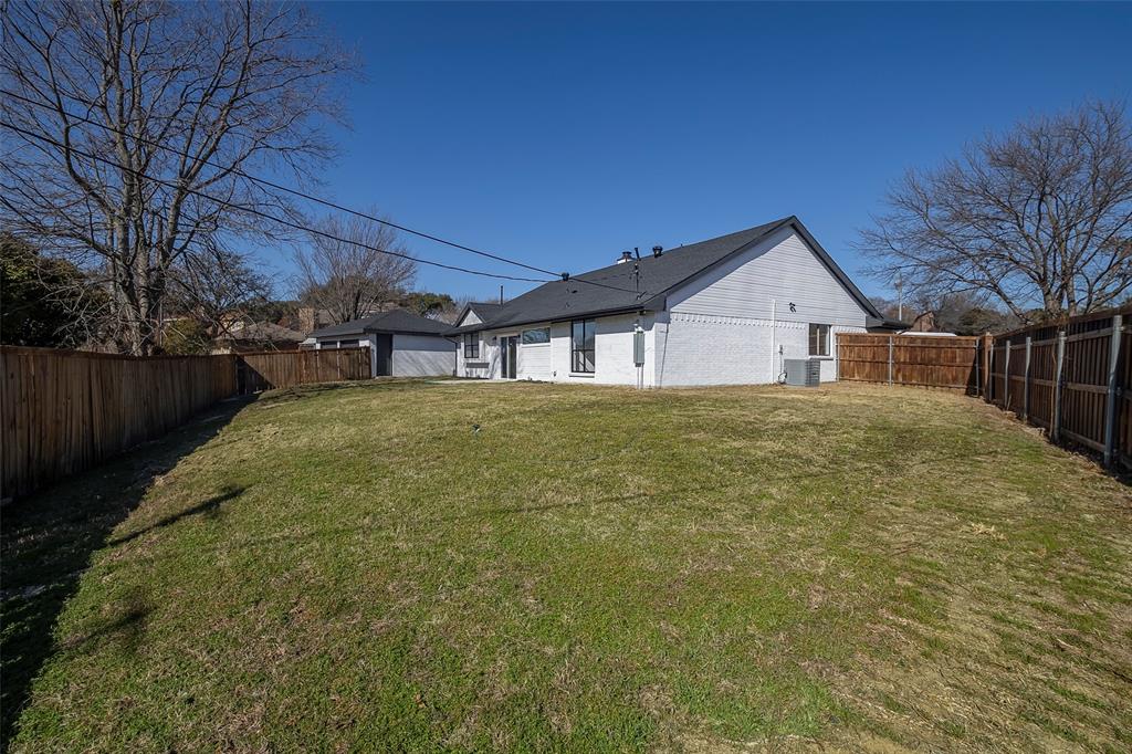 5607 Emrose Circle Dallas, TX 75227 - Photo 25 of 25 a view of a house with a yard and a garage