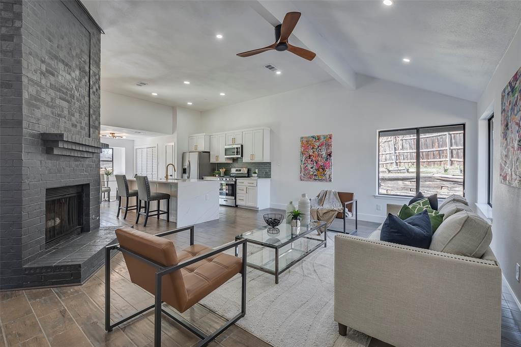 5607 Emrose Circle Dallas, TX 75227 - Photo 4 of 25 a living room with fireplace furniture and a ceiling fan
