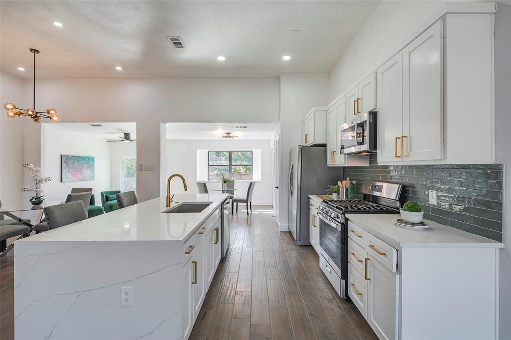 5607 Emrose Circle Dallas, TX 75227 - Photo 7 of 25 a large white kitchen with stainless steel appliances