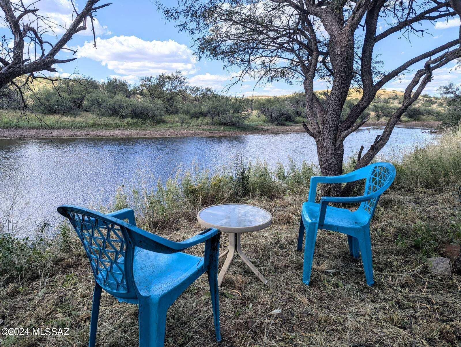 35700 South Cedar Creek Road Arivaca, AZ 85601 - Photo 26 of 44 a backyard with a table and chairs