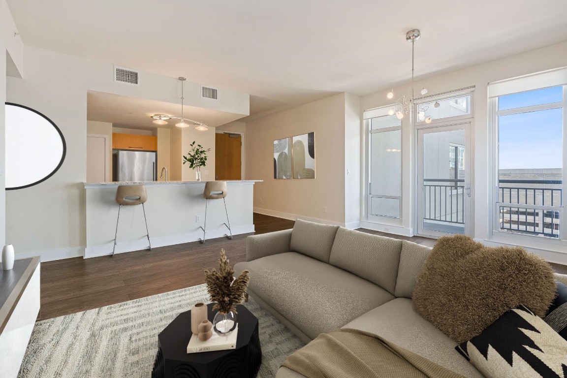 603 Davis Street, Unit 1304 Austin, TX 78701 - Photo 1 of 40 a living room with furniture and a wooden floor