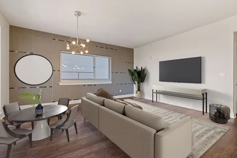 a living room with furniture a mirror and a flat screen tv