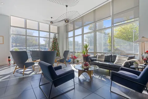a living room with furniture and a floor to ceiling window