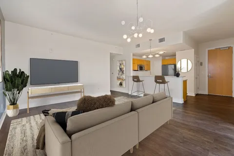 a living room with furniture and wooden floor