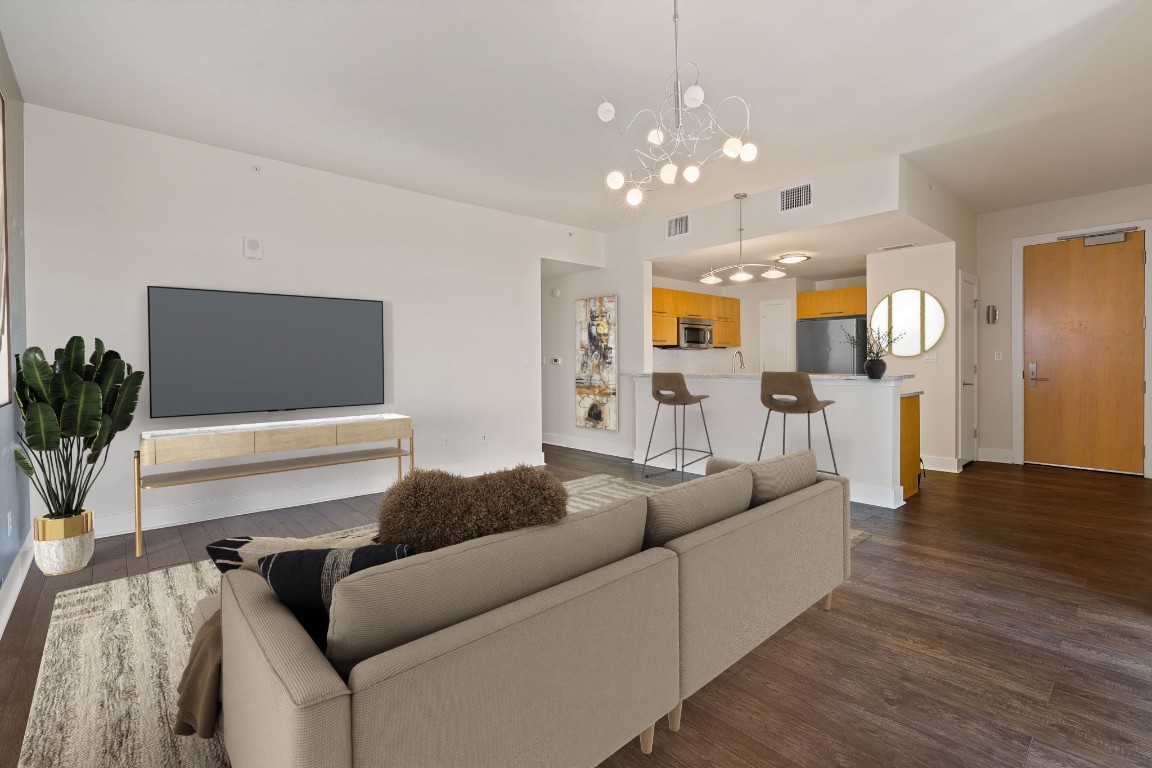 603 Davis Street, Unit 1304 Austin, TX 78701 - Photo 4 of 40 a living room with furniture and wooden floor