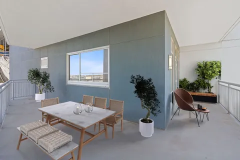 a living room with furniture potted plant and a window