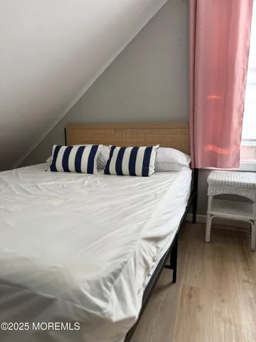 a bed sitting in a bedroom next to a window