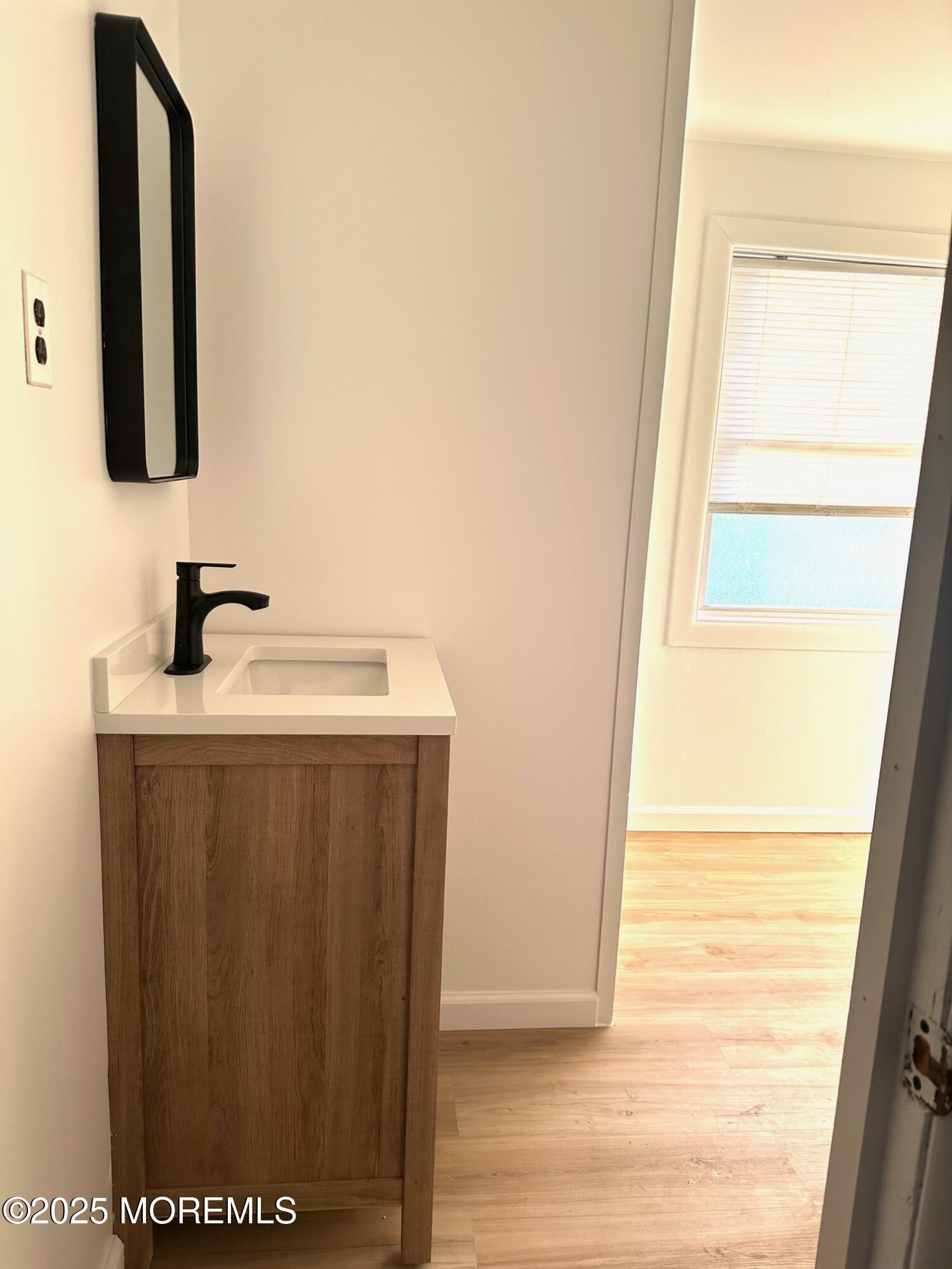 191 3rd Avenue, Unit 2 Manasquan, NJ 08736 - Photo 8 of 9 a bathroom with a sink and a mirror