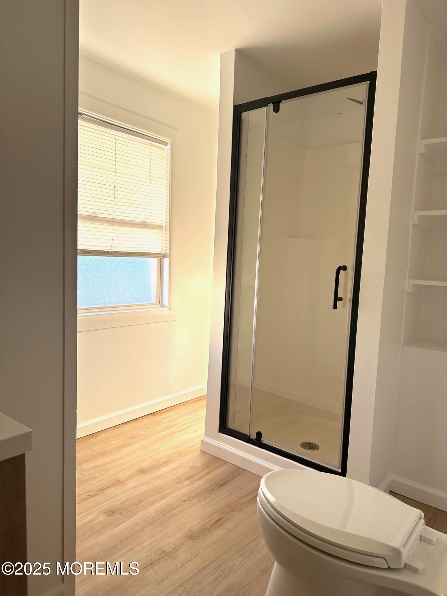 191 3rd Avenue, Unit 2 Manasquan, NJ 08736 - Photo 9 of 9 a bathroom with a glass door shower and a toilet