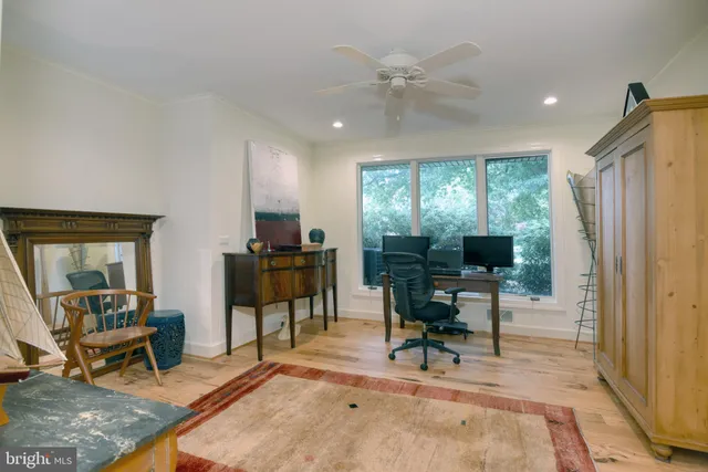 a view of a livingroom with workspace and a window