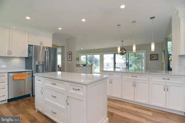 a kitchen with granite countertop cabinets and window