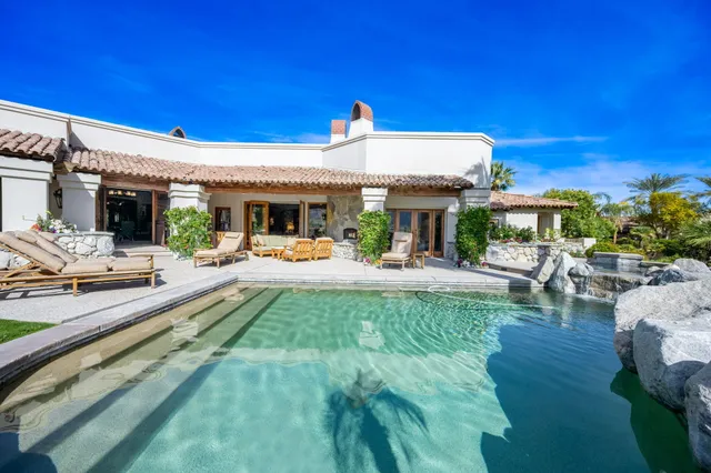 a living room with furniture a fireplace and a table