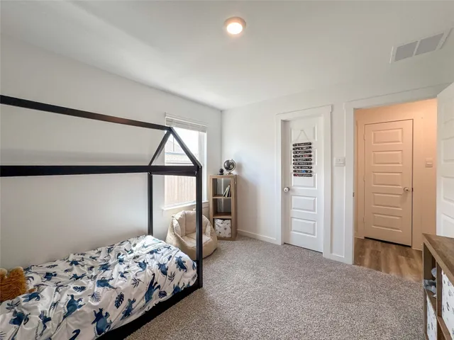 a bedroom with bed and a window