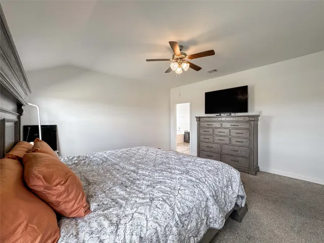 a bedroom with a bed and a television