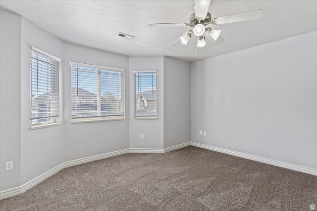 2350 South Highway 89, Unit 4 Perry, UT 84302 - Photo 24 of 30 Empty room with a ceiling fan and dark carpet