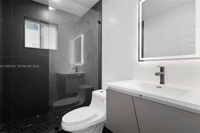 an empty room with wooden floor and window