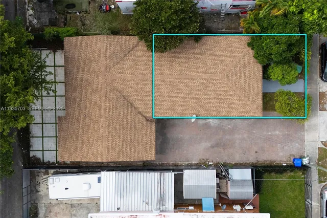 aerial view of a house with a yard