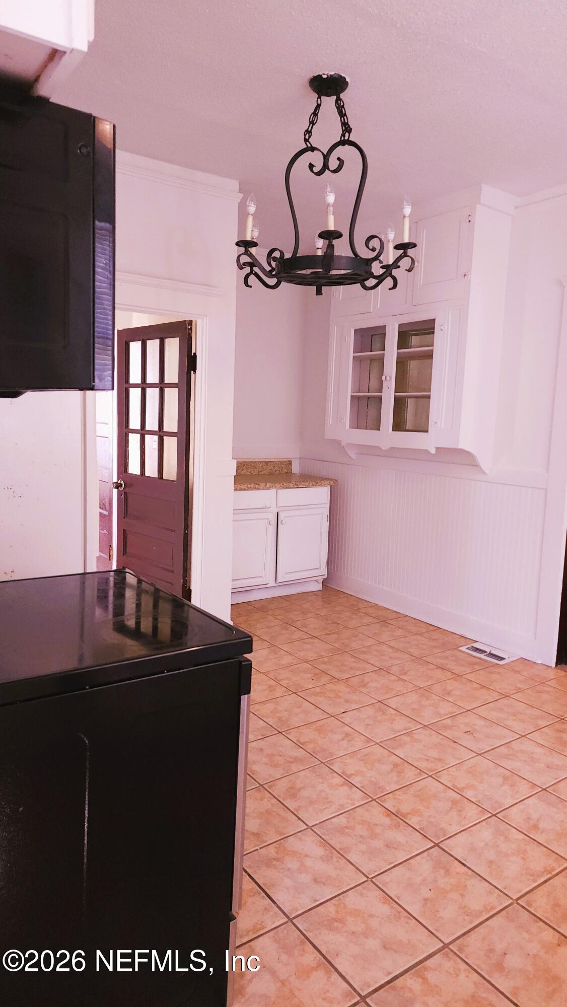 2036 Moncrief Road Jacksonville, FL 32209 - Photo 9 of 32 a bedroom with a bed and a dresser