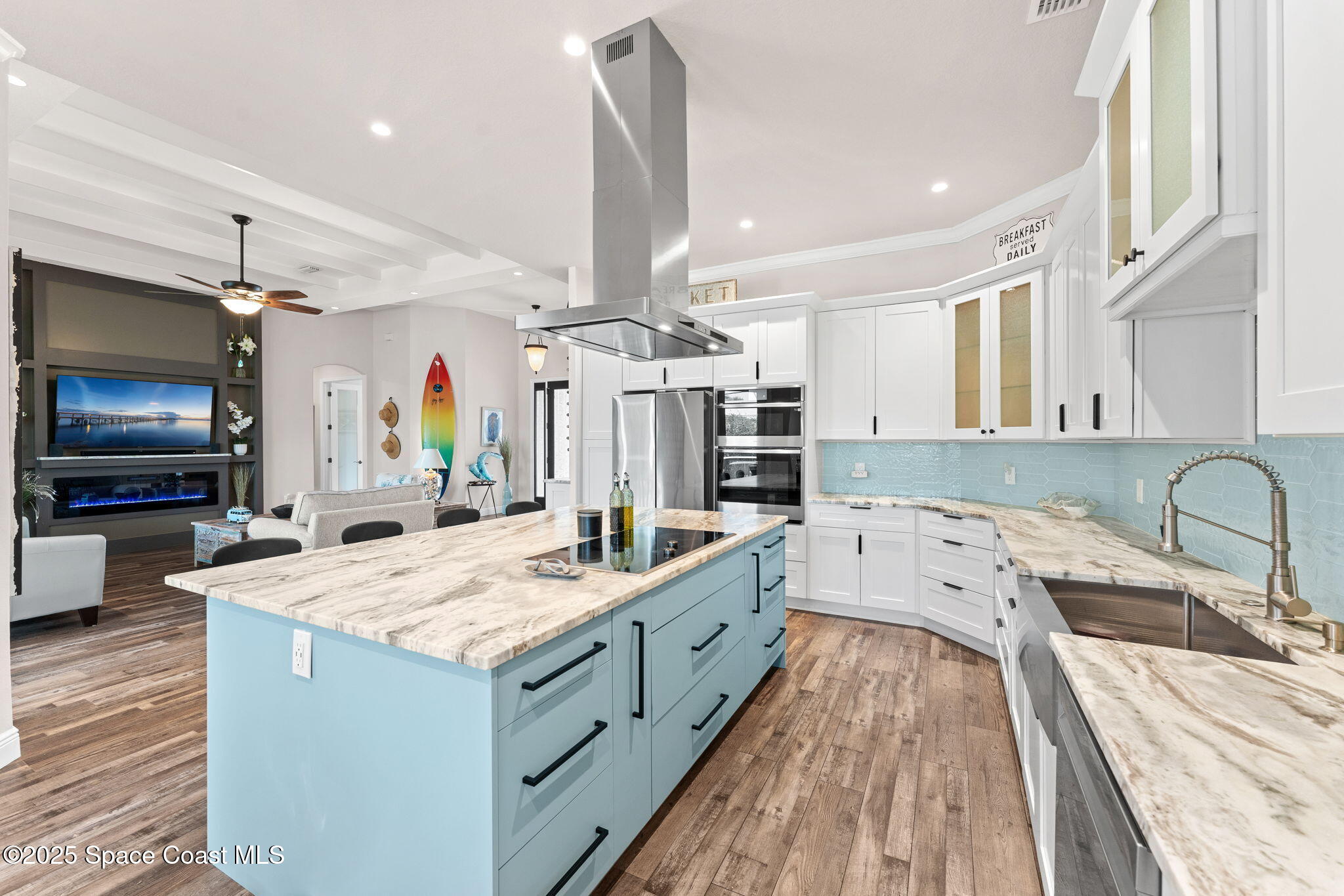 162 Miami Avenue Indialantic, FL 32903 - Photo 12 of 49 a large kitchen with kitchen island a large island in the center a sink stainless steel appliances and cabinets