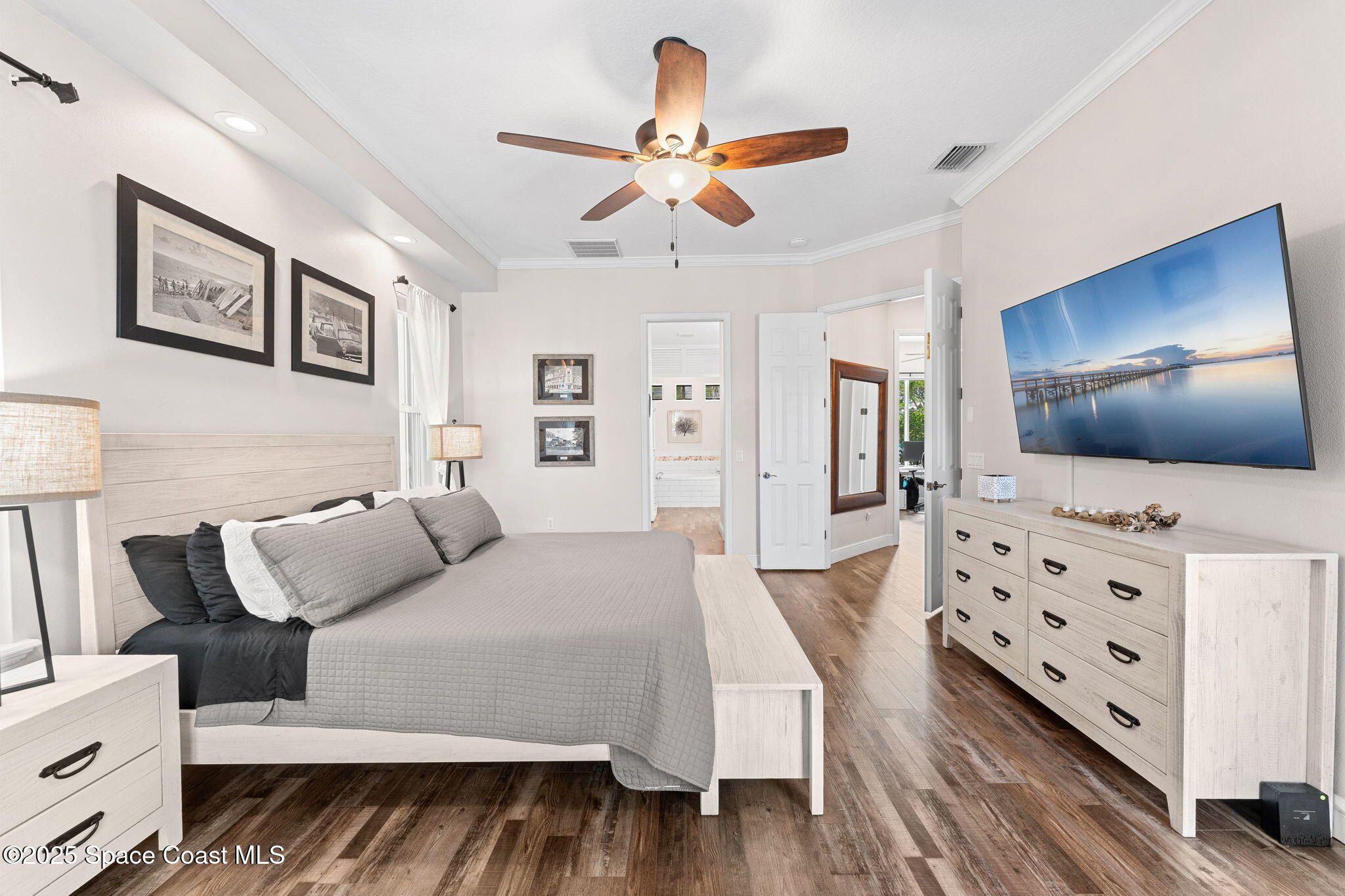 162 Miami Avenue Indialantic, FL 32903 - Photo 17 of 49 a spacious bedroom with a bed and a flat tv screen on dresser