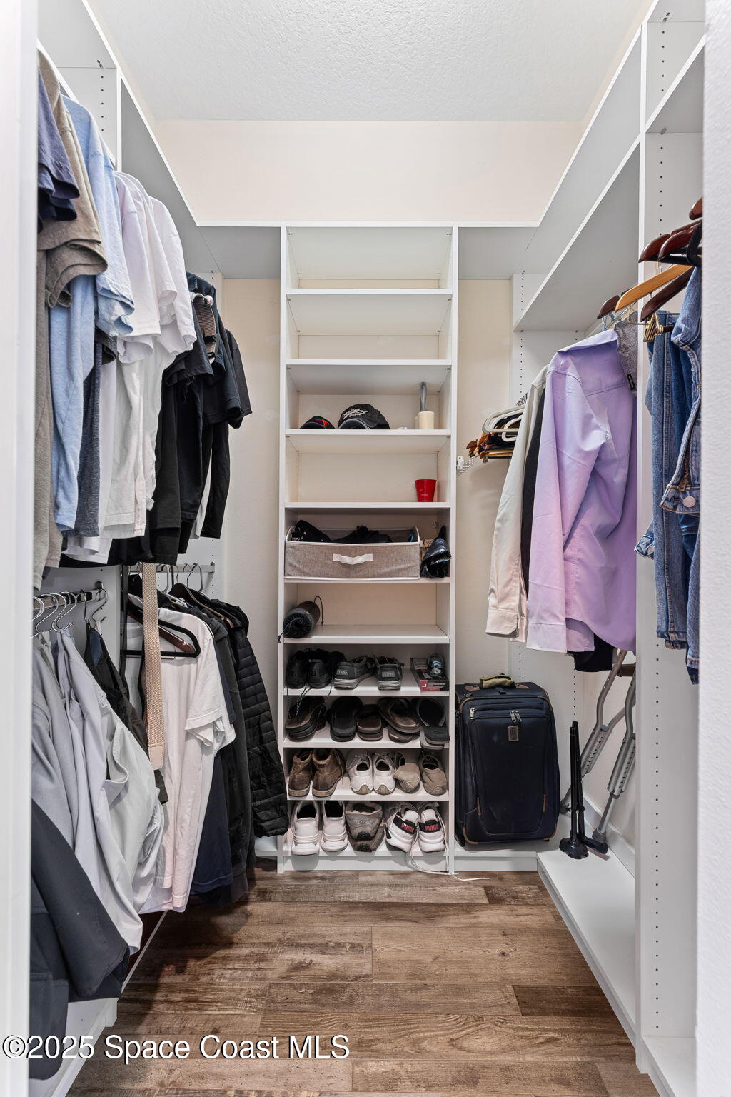 162 Miami Avenue Indialantic, FL 32903 - Photo 23 of 49 a view of walk in closet with clothes and shoes