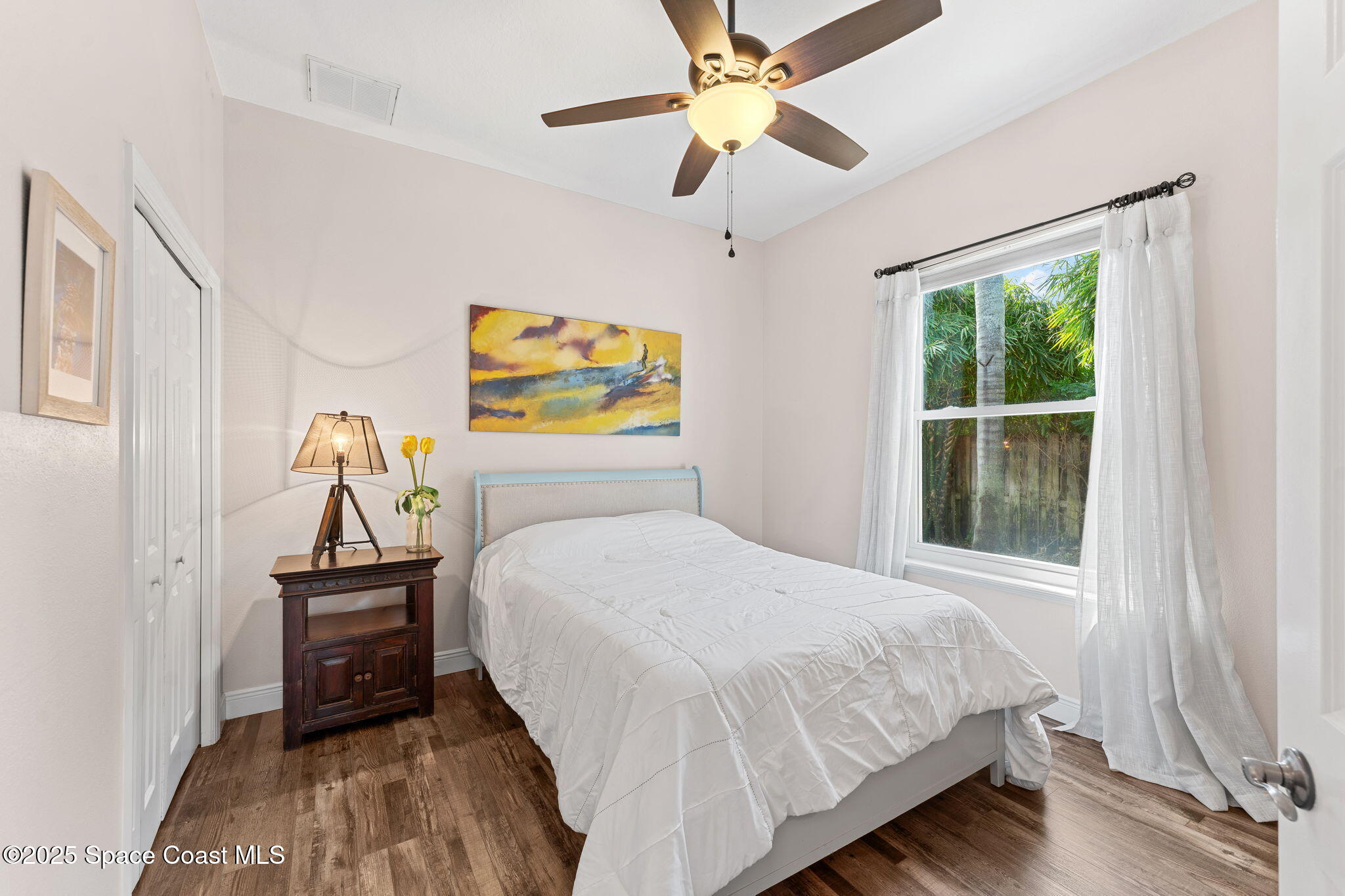 162 Miami Avenue Indialantic, FL 32903 - Photo 24 of 49 a bedroom with a bed and a chandelier