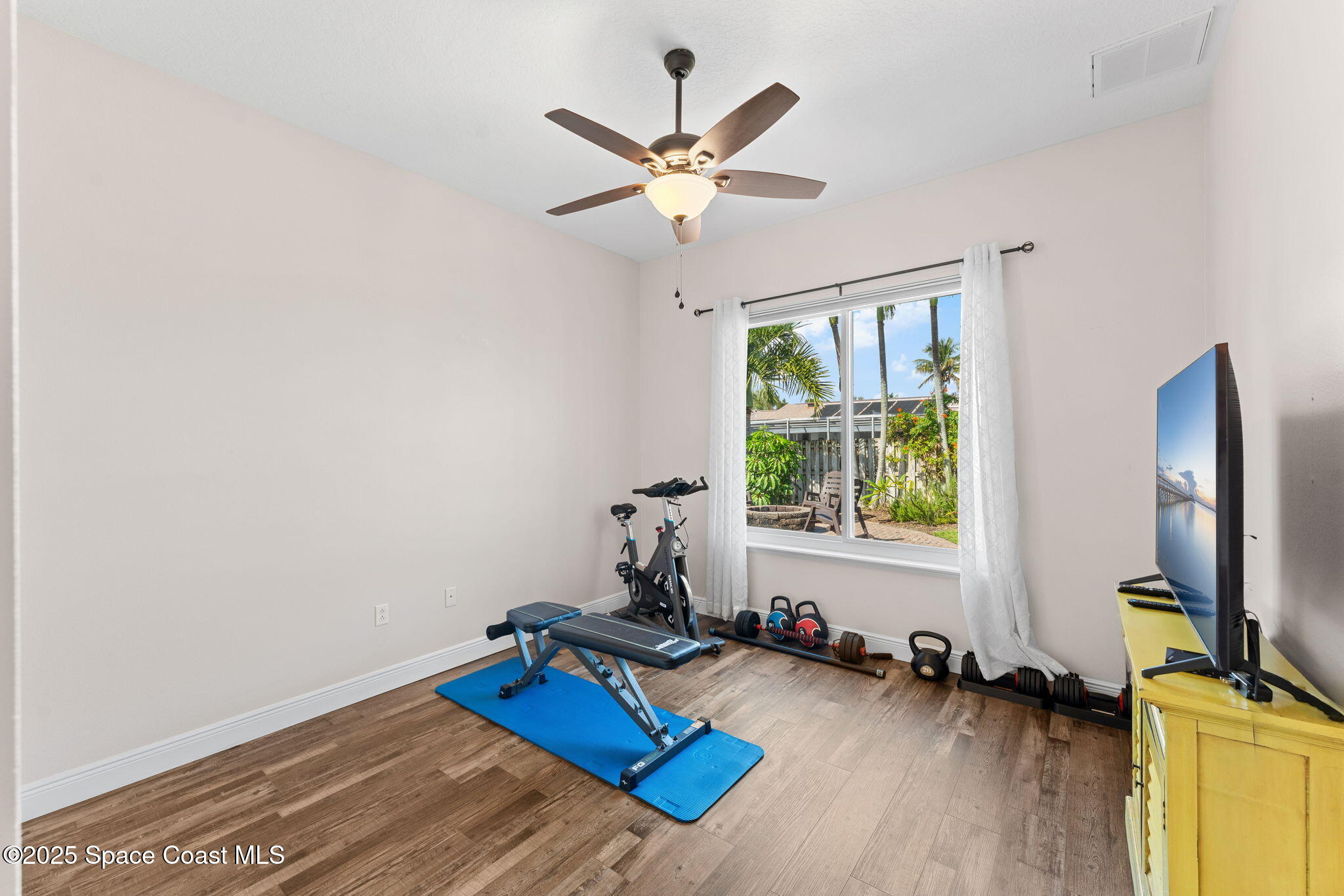 162 Miami Avenue Indialantic, FL 32903 - Photo 26 of 49 a room with gym equipment and a window